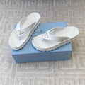 PRADA THICK-SOLED FLIP FLOPS IN WHITE RUBBER
