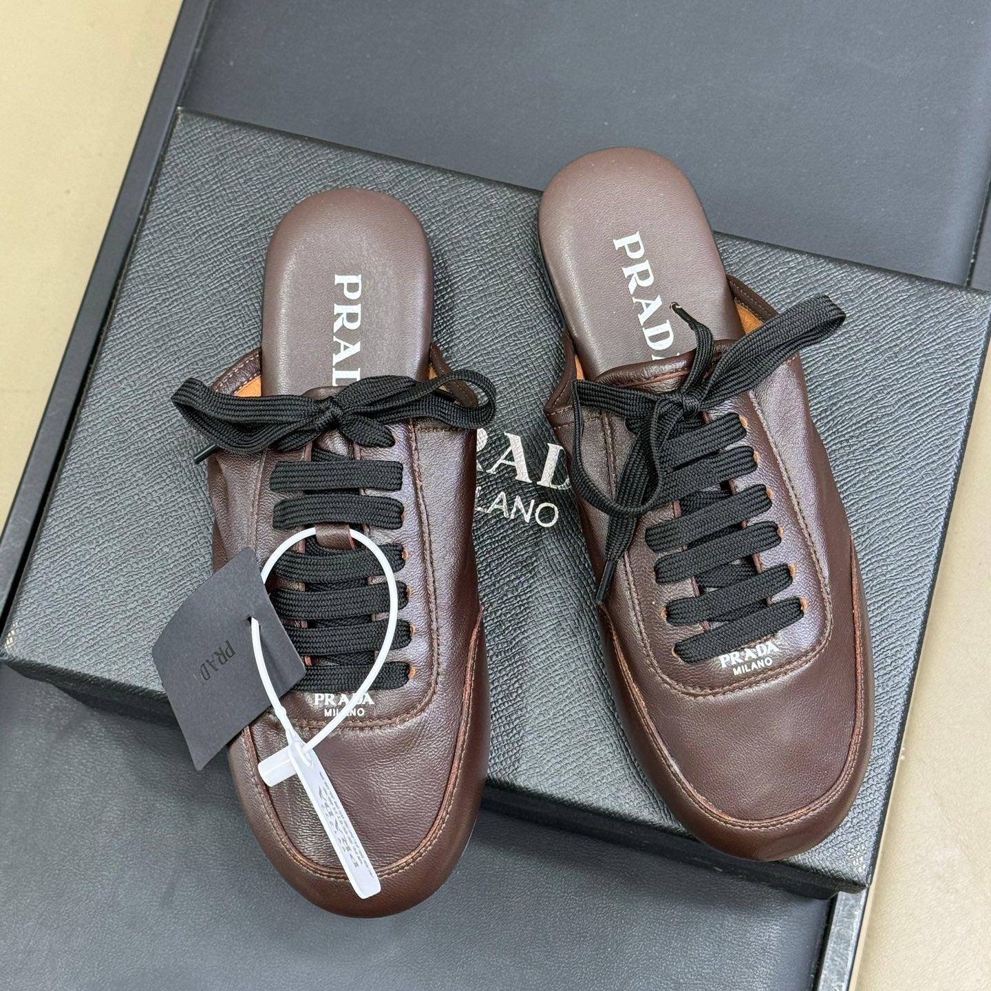 PRADA 25S COLLAPSE MULES IN RK BROWN CALFSKIN